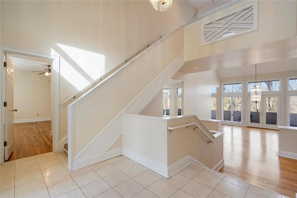 Staircase with a high ceiling and light hardwood / wood-style floors