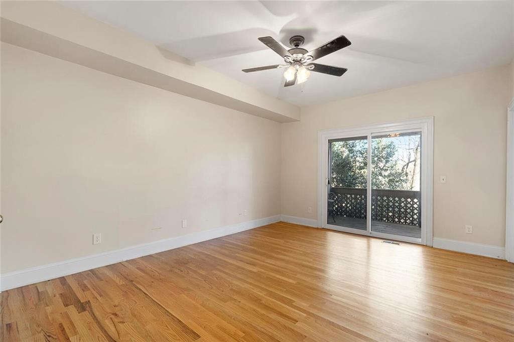 Empty room with ceiling fan and light hardwood / wood-style floors