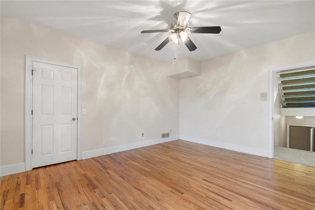 Empty room with light hardwood / wood-style flooring and ceiling fan