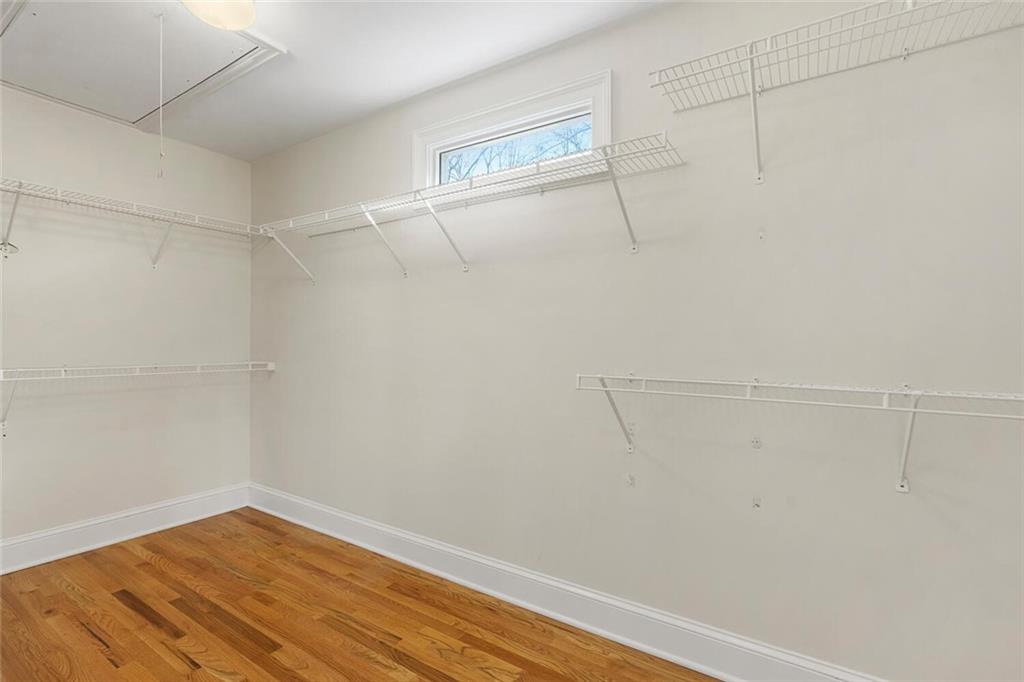 Spacious closet featuring light wood-type flooring