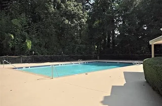 Community pool featuring a patio