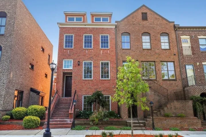 Brick exterior with multi-pane windows and a dormer