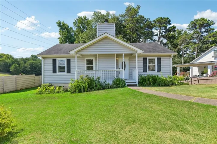 Single-story home featuring light grey siding, a covered front porch, and a sidewalk leading to the entrance