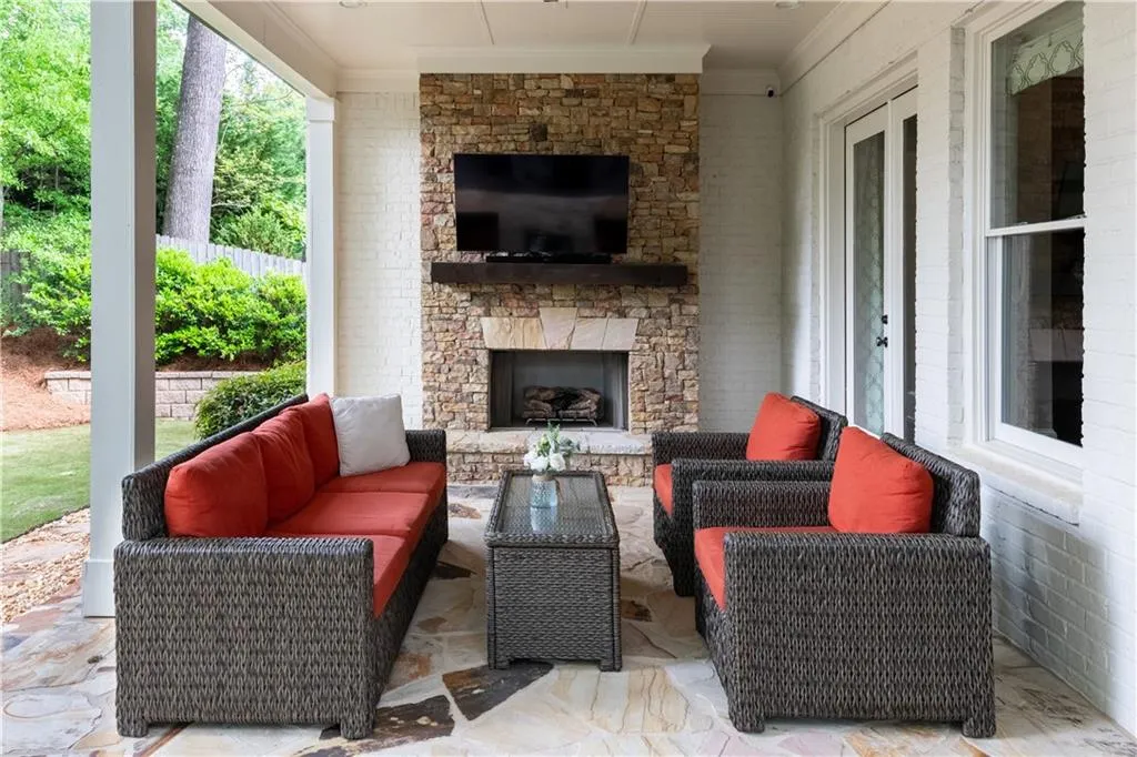 Walkout to Covered Porch with Stone Fireplace