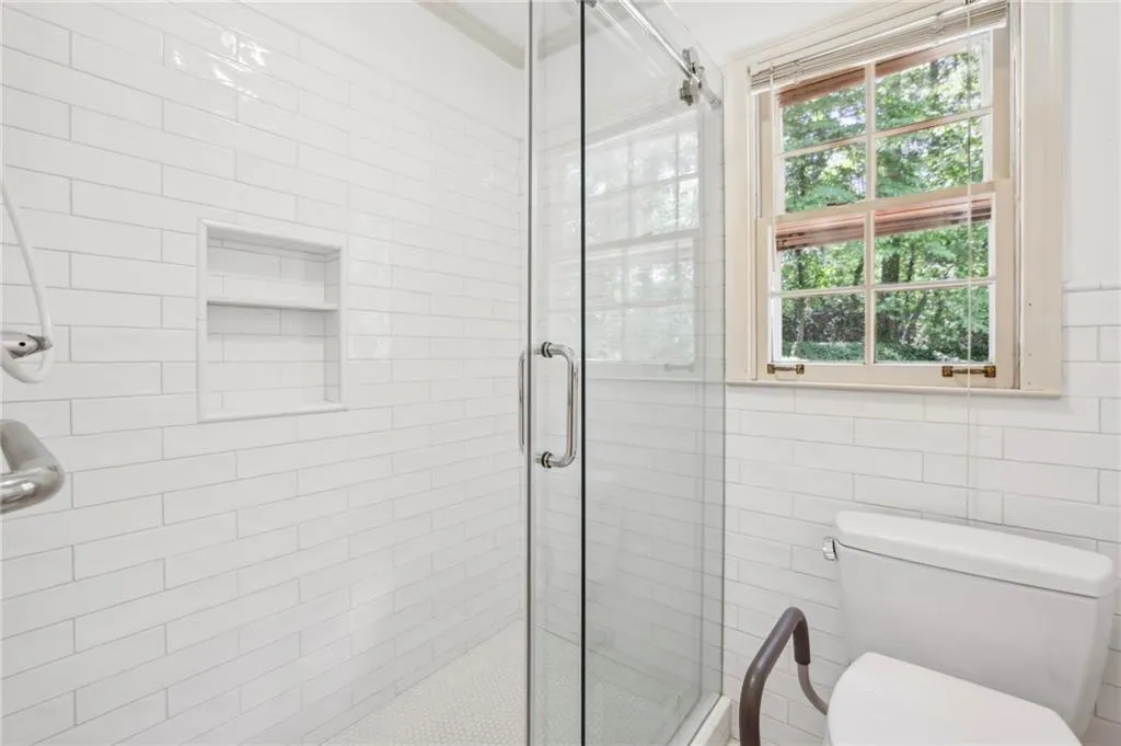 Primary Bathroom featuring walk in shower, plenty of natural light