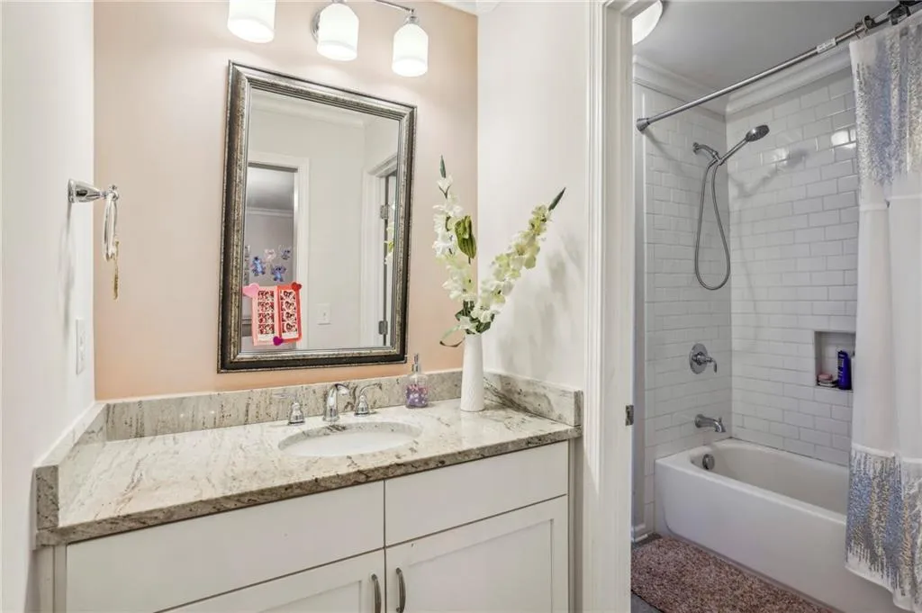 Jack & Jill Bathroom with shower / bath combo and vanity