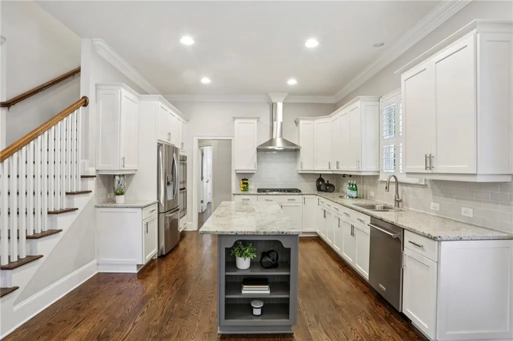 Kitchen featuring open shelves, white cabinets, a center island, dark wood-style flooring, and ornamental molding