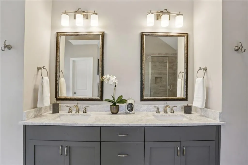 Full bath with a stall shower and double vanity