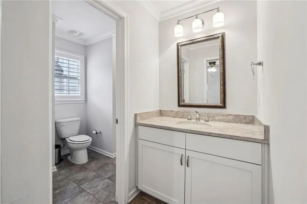 Bathroom with vanity and ornamental molding