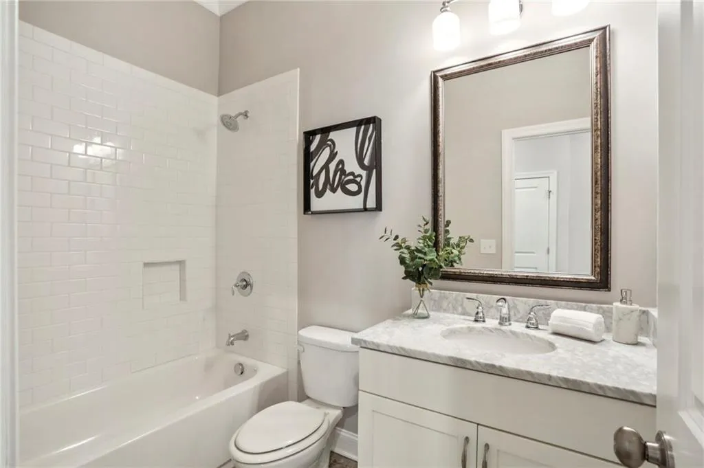 Bathroom on first floor with bathing tub / shower combination and vanity