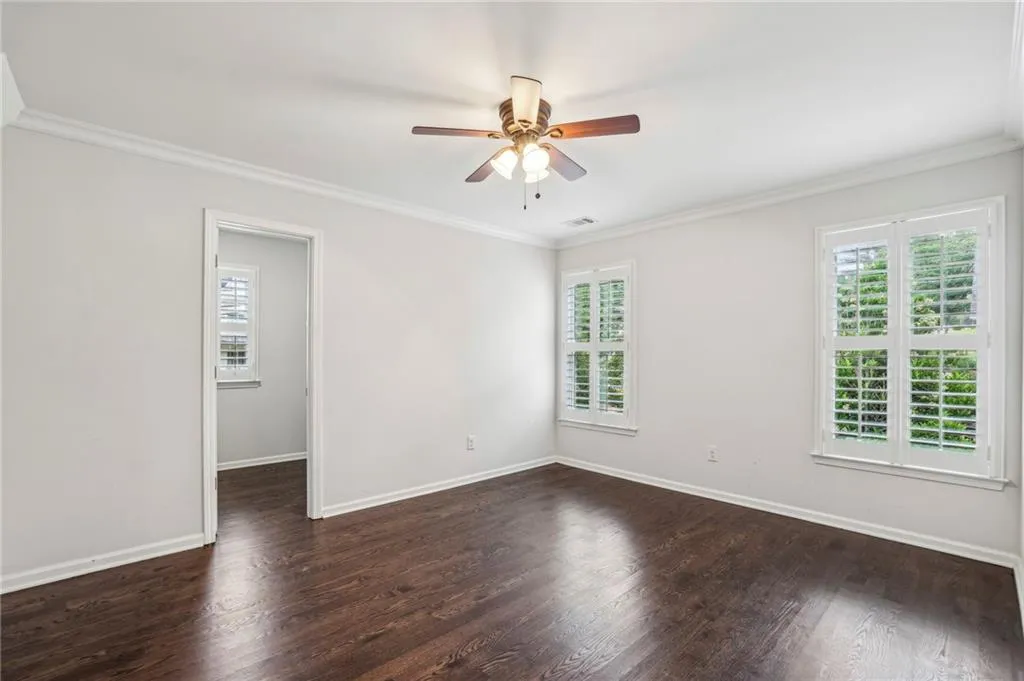 Bedroom #4 featuring access to a Jack & Jill bath  crown molding, dark hardwood floors, and a chandelier
