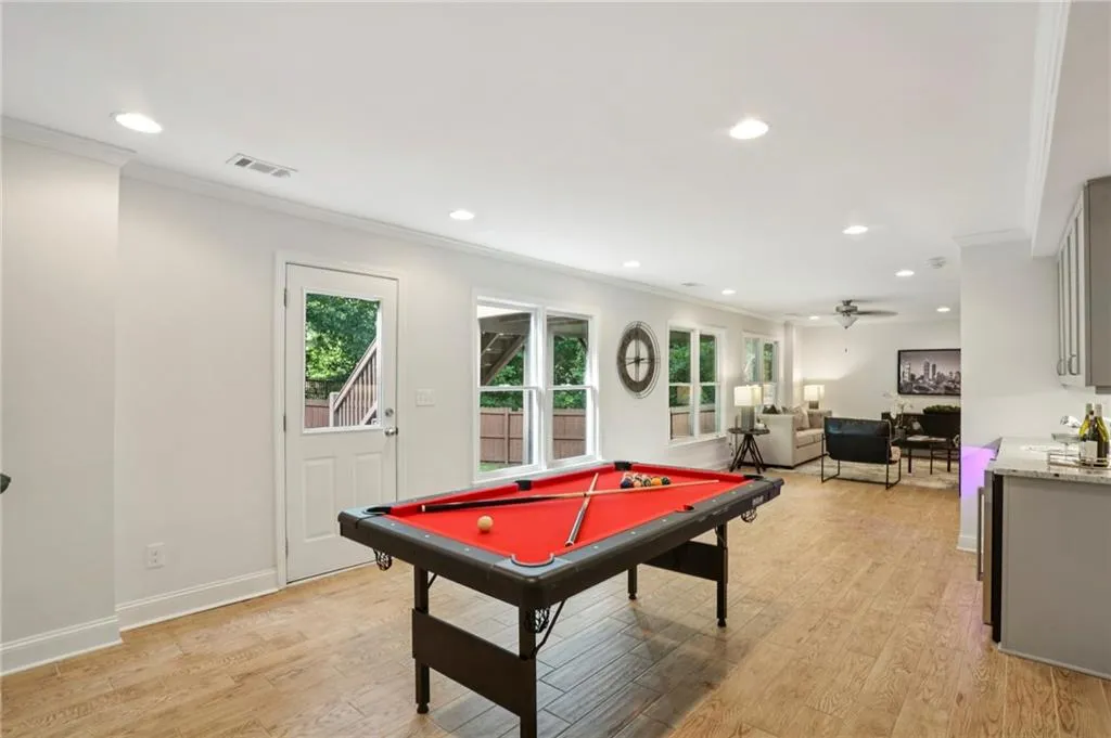 Rec room featuring crown molding, billiards, light wood finished floors, recessed lighting, and a ceiling fan