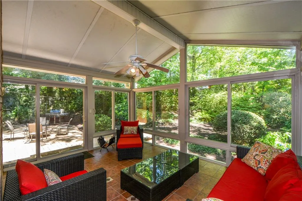 Sunroom / solarium featuring ceiling fan and lofted ceiling Sunroom / solarium featuring ceiling fan and lofted ceiling