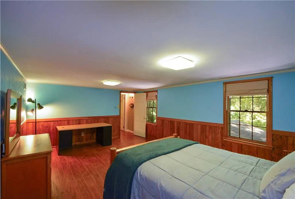 Bedroom featuring dark hardwood / wood-style flooring and crown molding Bedroom featuring dark hardwood / wood-style flooring and crown molding