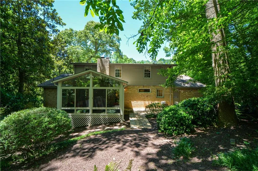 Back of house featuring a sunroom Back of house featuring a sunroom