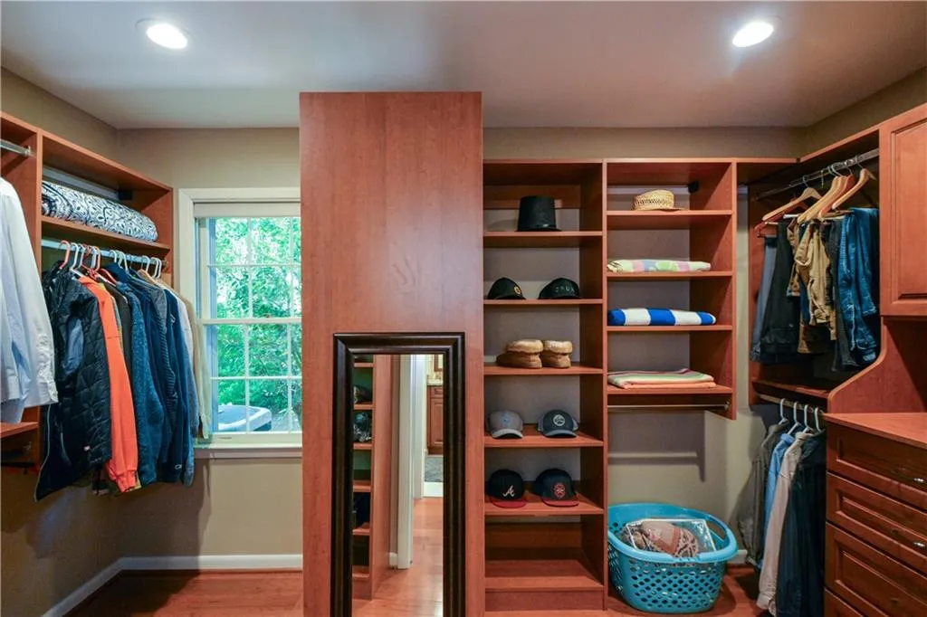 Walk in closet featuring hardwood / wood-style flooring Walk in closet featuring hardwood / wood-style flooring