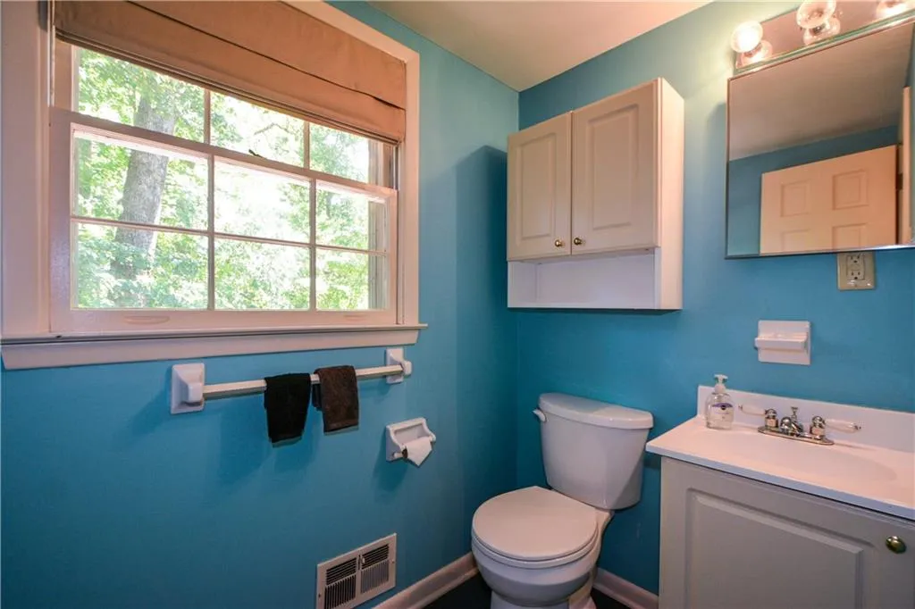 Bathroom featuring vanity and toilet Bathroom featuring vanity and toilet