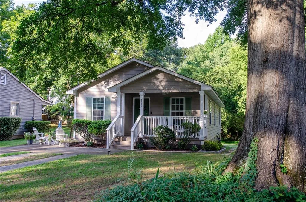 Bungalow with a porch and a front yard