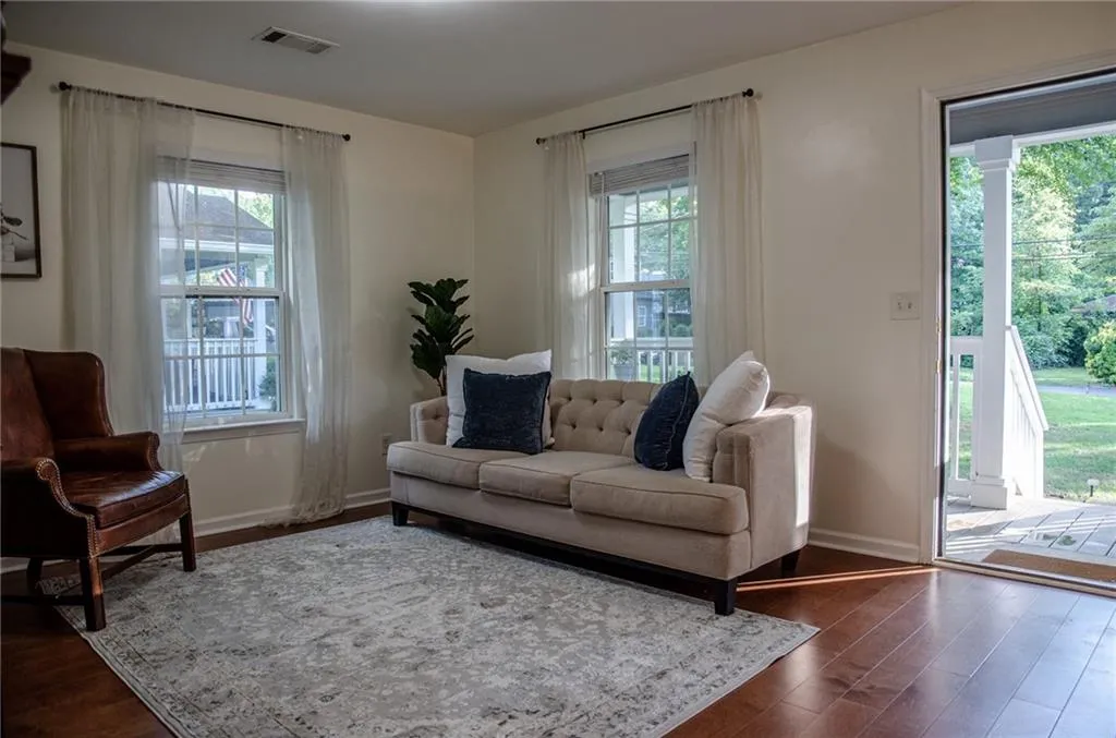 Living area with dark wood-style flooring and plenty of natural light