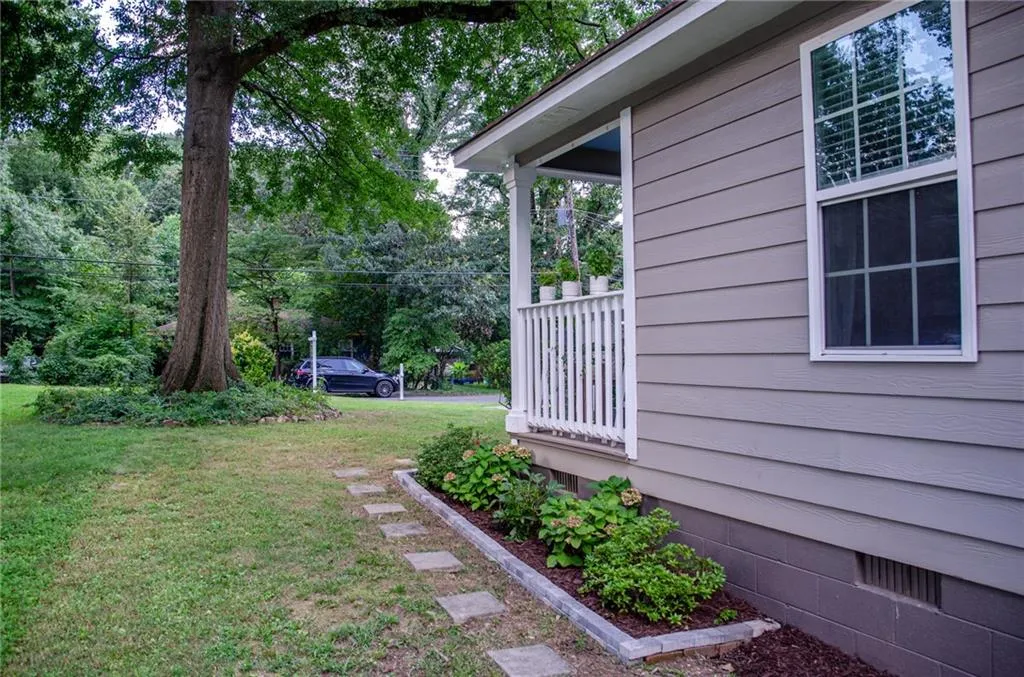 View of grassy yard featuring view of scattered trees