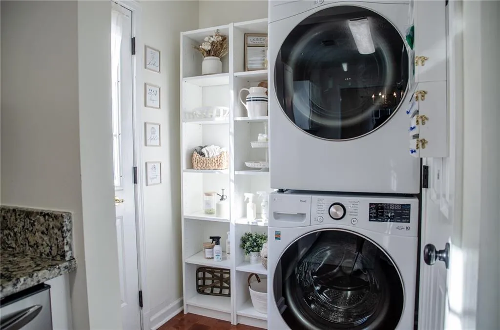 Laundry area featuring stacked washing machine and dryer