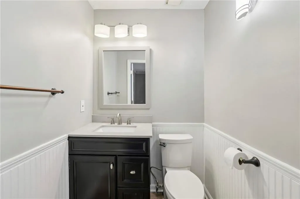 Bathroom featuring a wainscoted wall and vanity
