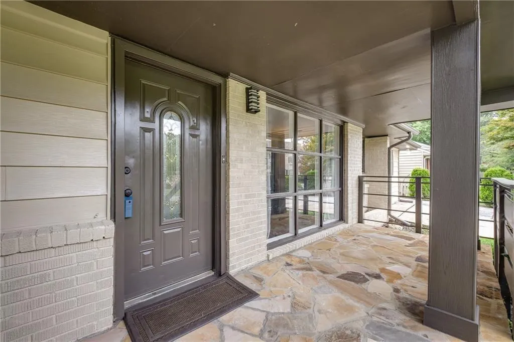 Covered flagstone front porch with picture window from living room