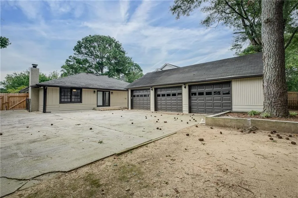 Gated back yard includes a large courtyard/driveway and a huge detached 3 car garage with extra storage