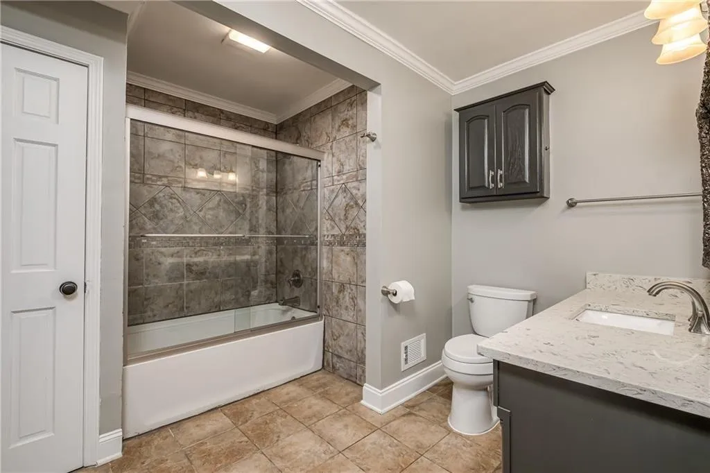 Renovated Primary Bathroom includes beautiful tiled shower/tub with tiled floor