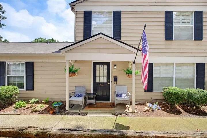 Tan siding exterior with a covered porch entry