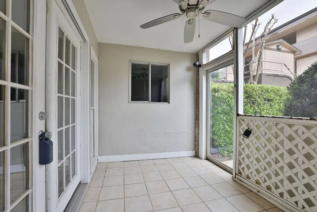 Unfurnished sunroom featuring french doors, ceiling fan, and a wealth of natural light