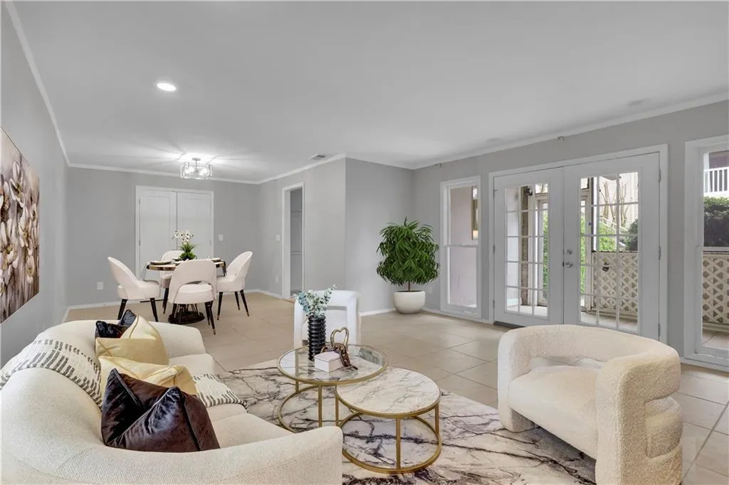 Tiled living room with french doors and ornamental molding