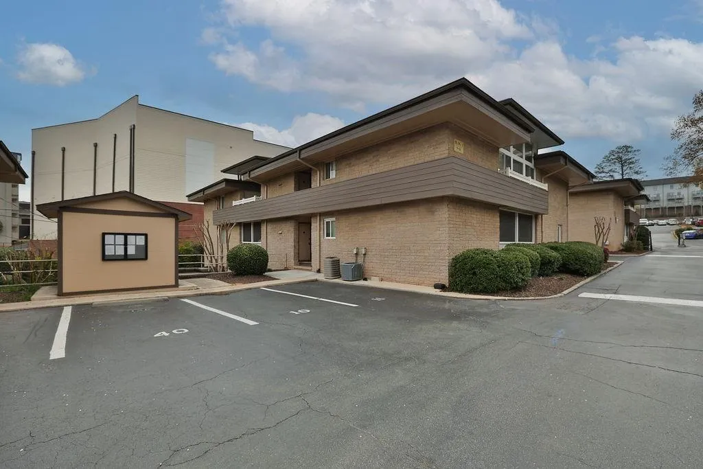 View of building exterior with central AC unit