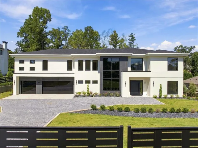 Contemporary architectural design with a white stucco exterior and dark trim accents