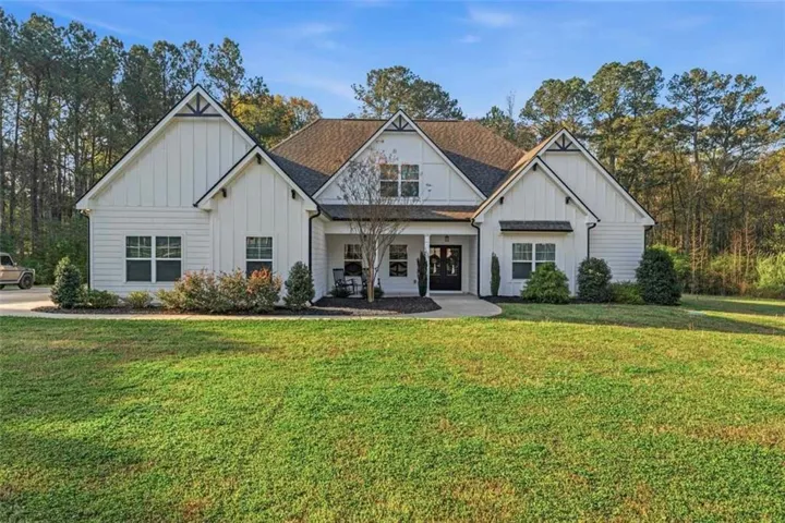 Modern farmhouse exterior with white siding and dark trim accents
