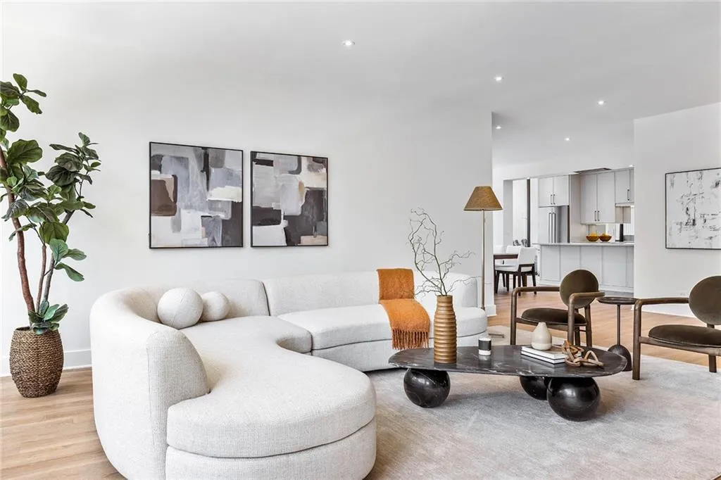 Open-concept interior featuring light wood-finish flooring, recessed lighting, and a neutral color palette