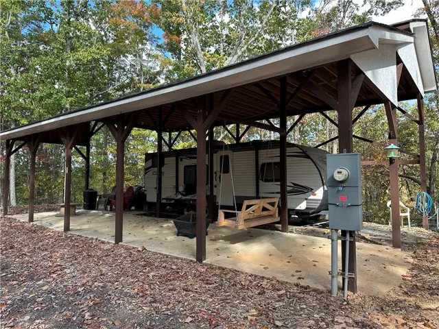 Spacious outdoor carport structure with a durable roof and exposed wood beams