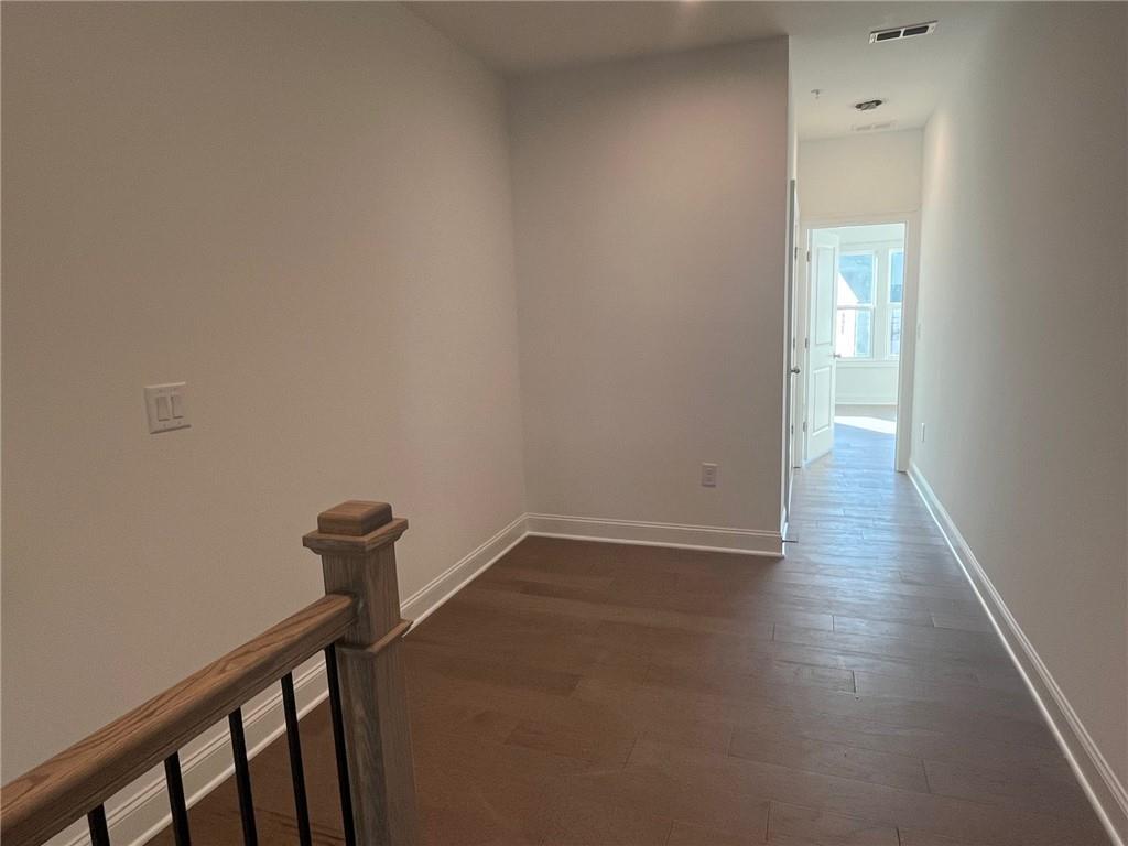 Unfurnished room featuring dark wood-type flooring