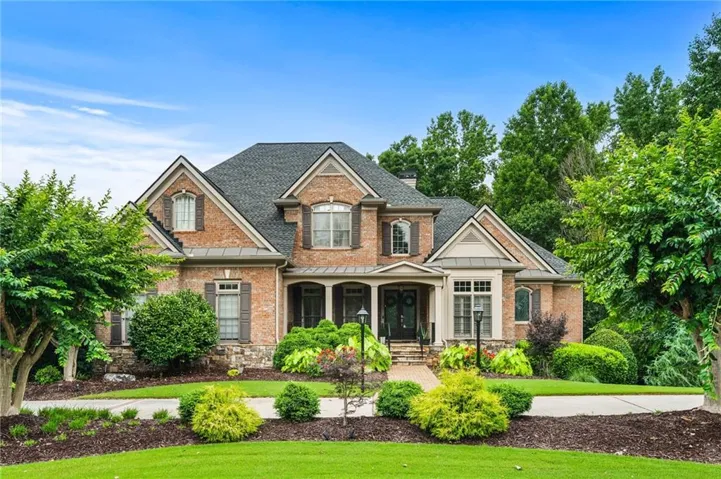 John Wieland four side brick home with circular drive.