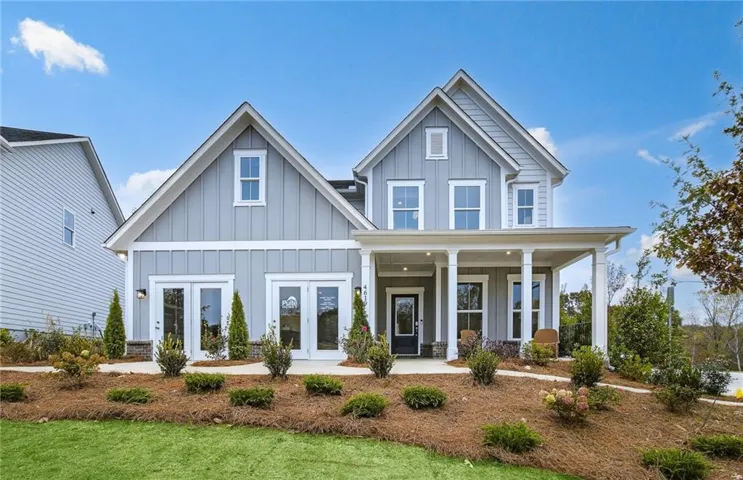 Board and batten siding, covered front porch, multiple gables, and dual French doors