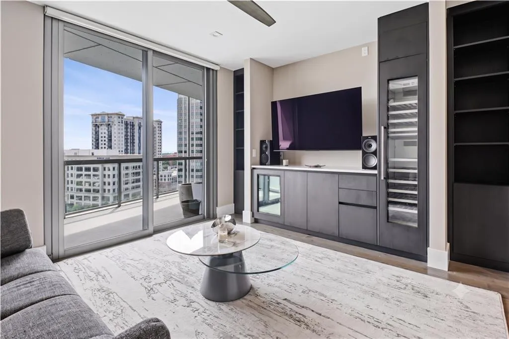 Den or additional living area with built in cabinetry and beverage fridge