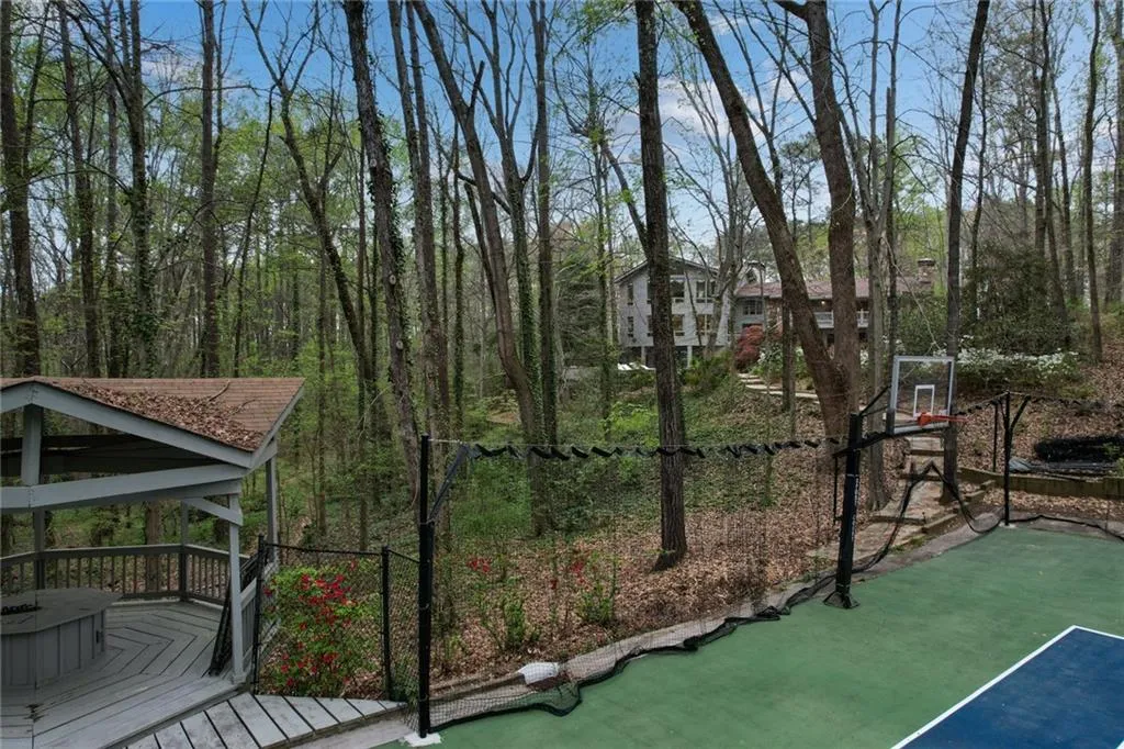 View of tennis court with a gazebo