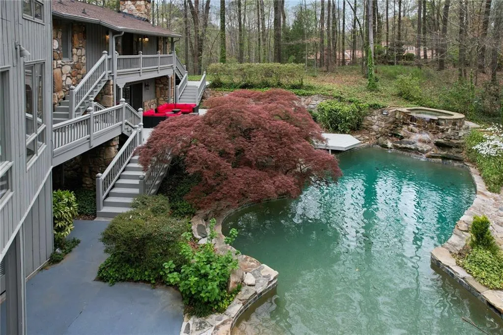 View of pool with a hot tub