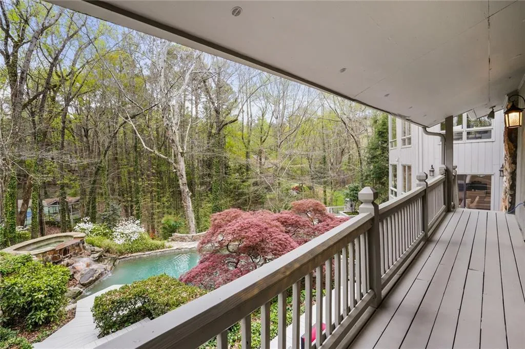 Wooden deck with a pool with hot tub