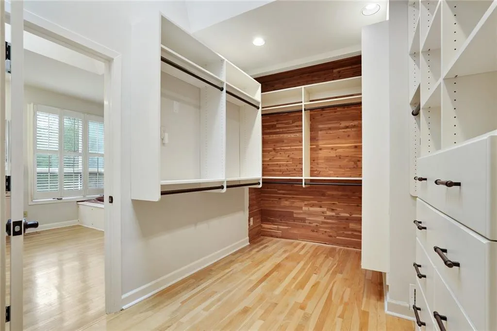 Primary spacious closet with light hardwood / wood-style floors