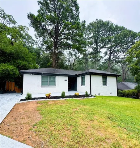 Modern ranch-style home featuring a freshly updated exterior with crisp white siding and black trim accents
