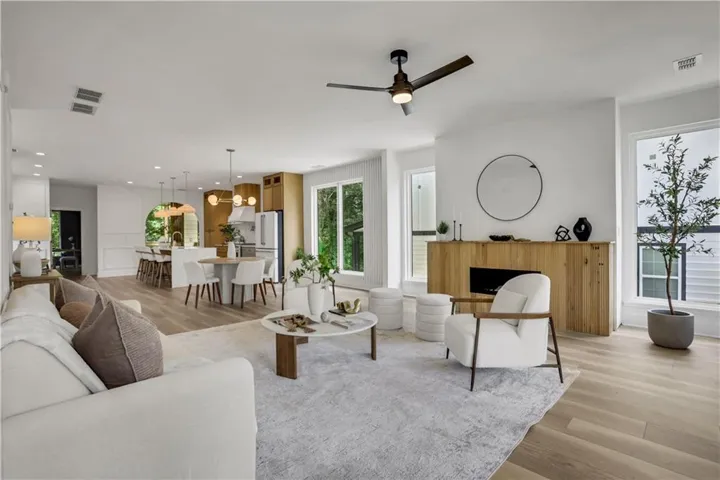 Open-concept living space featuring wood-finish flooring and recessed lighting