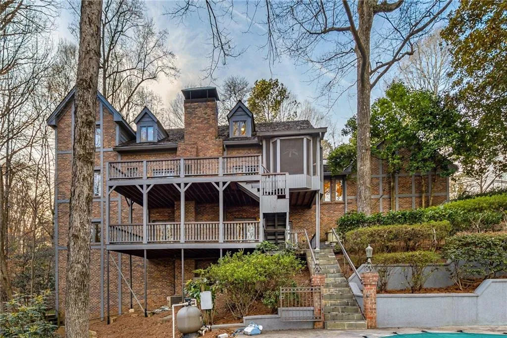 Rear view of property with stairs, a chimney, and a deck