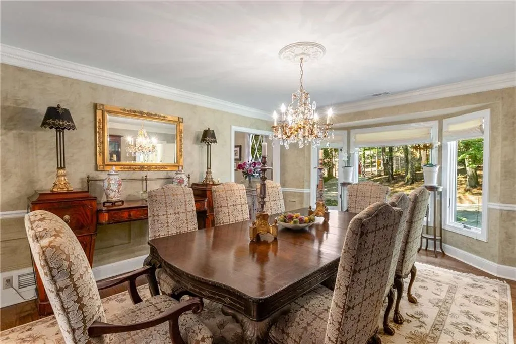 Dining room located at front of home features hardwood flooring, hand plastered walls and lovely molding.