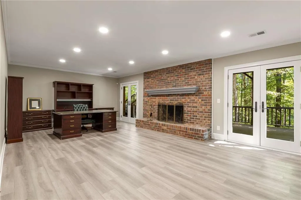 Day-light terrace level family room or office with LVP flooring creates a great space for teen suite or in-law suite.